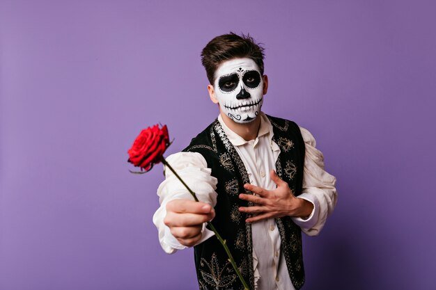 man with mexican dead makeup holding red flower emotional guy traditional spanish clothes 197531 16191